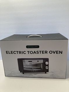 an electric toaster oven sitting on top of a white counter next to a wall