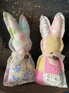 two stuffed bunnies sitting on top of a chair