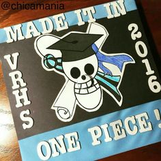 a blue and black banner with a skull wearing a mortar cap on it that says made it in 2013, one piece