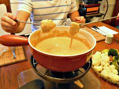 a man is dipping some food into a bowl