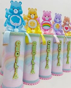 a group of teddy bears sitting on top of each other in small containers with ribbons