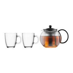 a tea pot with two cups next to it