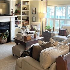 a living room filled with furniture and a flat screen tv mounted on a wall above a fire place