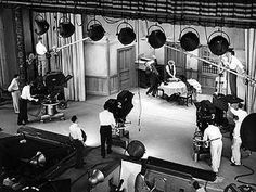 an old black and white photo of people in a room