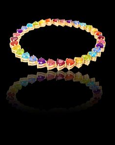 The full rainbow fantasy in the most unique and colorful bracelet to light up your life! This tennis bracelet is like no other consists of heart settings with colored gems and sapphires in the Classic Mordekai rainbow pattern. Goes perfect with our matching eternity rainbow rings! Height: 5/8" Length: 7" Stone: 5mm x 5 mm Stones are: Garnet, Orange Sapphire, Yellow Sapphire, Peridot, Blue Topaz, Blue Sapphire, Amethyst, and Pink Tourmaline Made in America. set in 14k yellow gold, white gold, or rose gold Heart Tennis Bracelet, Full Rainbow, Bracelet Rainbow, Colorful Bracelet, Rainbow Rings, Orange Sapphire, Colored Gems, Rainbow Heart, Rainbow Pattern