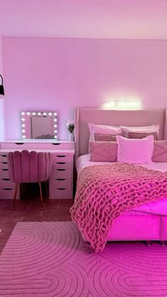 a bedroom with pink walls and carpeted flooring is pictured in this image, the bed has a purple blanket on it