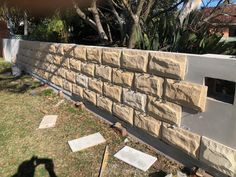 a stone wall in front of a house