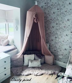 a canopy bed in the corner of a room with floral wallpaper and white furniture