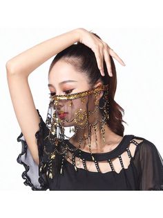 a woman with her hands on her head, wearing gold jewelry and black top over white background