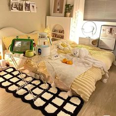 a bed room with a neatly made bed and various items on the floor next to it