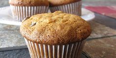 three muffins sitting on top of a white plate