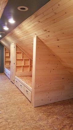 an unfinished attic with wooden walls and flooring