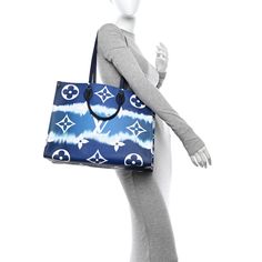 This is an authentic LOUIS VUITTON Monogram Escale Onthego GM in Blue. This limited edition tote features oversized and smaller versions of the classic Louis Vuitton monogram printed in white on a blue tie-dye coated canvas. The bag features dark blue rolled top handles and longer shoulder straps that can be tucked away inside the bag, accented with polished silver hardware. The top is open to a spacious mini monogram printed blue fabric interior with zipper and patch pockets. Monogram Prints, Blue Tie, Blue Tie Dye, Blue Fabric, Authentic Louis Vuitton, Silver Hardware, Patch Pocket, Louis Vuitton Monogram, Shoulder Straps