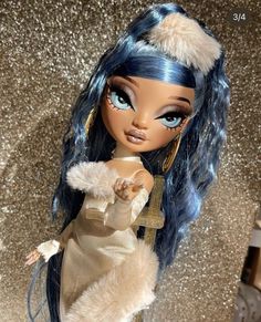 a close up of a doll with blue hair and fur on it's head