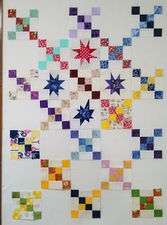 a wall hanging made up of squares and stars