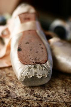 an old pair of shoes sitting on top of a counter