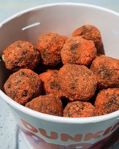 a white bowl filled with carrots sitting on top of a table next to a napkin