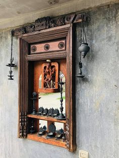 an old wooden cabinet with chess pieces in it's display case on the wall