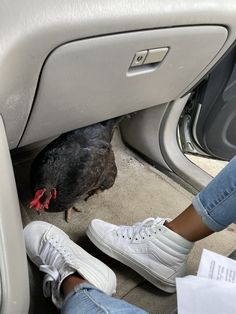 a person sitting in the passenger seat of a car with their feet on the floor