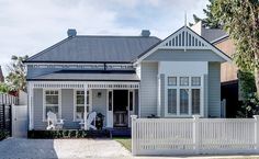 a house with white picket fence in front of it