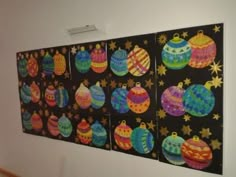 an art piece is hanging on the wall in front of a black background with colorful ornaments and stars