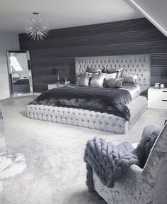 a bed room with a neatly made bed and pillows