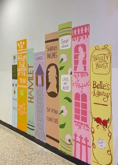 a wall with many different colored books painted on it's sides and the words hello kitty above them