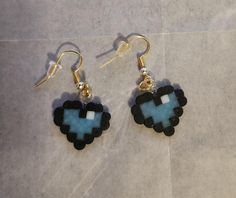 a pair of earrings with blue and black beads