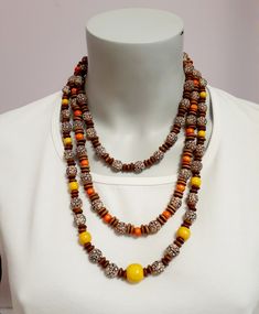 Wooden and Acrylic beads with accent wooden beads in 3 colors - all brown & beige, brown/beige & orange, and brown/beige & yellow.  The  18 inch necklace is designed with brown/ beige  10 mm acrylic beads  that are imprinted with a flower design and separated with 3 brown wood rondelle beads.  The 23 inch necklace consists of the same flowered design brown/beige beads and 8mm orange wood beads separated with 2 brown wood rondelle beads.  The 28 inch necklace is accented with yellow wood beads in sizes 12, 10 & 8 mm with the same brown/beige flower beads and separated by 2 brown wood rondelle beads.   The 18 & 23 inch necklaces  have a lobster clasp closure. These necklaces are very rustic and lightweight, suitable for casual wear. Brown Necklaces With Round Wooden Beads, Brown Necklace With Round Wooden Beads, Yellow Wood, Orange Wood, Wood Bead Necklace, Bead Necklaces, Flower Beads, Beige Brown, Acrylic Beads