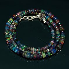 "Natural Welo Fire Ethiopian Black Opal Plain Beads Beautiful Necklace. Bead Shape : Rondelle bead Fire : Multi Welo Fire. Coloure : Black. Length : \"16\" Inches With Size Adujstable Chain upto \"18\" inches. Beads Size : 2.5 To 5.5 mm. Welo Fire Opal Gemstone Jewelry/Necklace." Handmade Opal Jewelry, Chip Bead Necklace, Fire Opal Necklace, Necklace Bead, Fancy Beads, Magical Jewelry, Opal Bracelet, Cool Necklaces, Beautiful Necklace