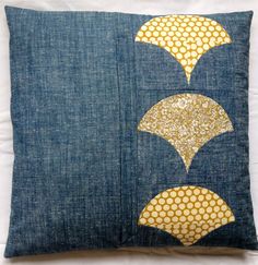 a blue pillow with gold sequins on it