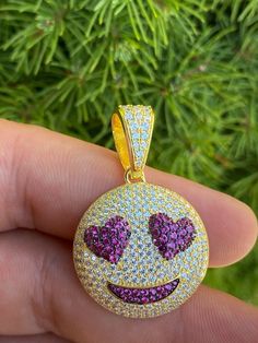 "Super cute custom made Smiley Face Heart Eyes emoji pendant! Great for men or ladies SUPER ICY! Solid 925 sterling silver...never turns green Stamped 925 We have 2 styles! Natural silver finished & 14k yellow gold finished! Measures roughly 1\" by 1\" (1.25\" w. bale) ...weighs roughly 11 grams 200 micropaved handset simulated diamonds (CZ) CHAIN IS NOT INCLUDED Fits up to 6mm chains" White Novelty Jewelry For Valentine's Day, Novelty White Jewelry For Valentine's Day, Valentine's Day White Novelty Jewelry, Novelty Smiley Face Jewelry As Gift, Novelty Smiley Face Jewelry For Gifts, Novelty Smiley Face Jewelry For Gifting, Novelty Smiley Face Jewelry Gift, White Smiley Face Jewelry For Gifts, White Smiley Face Jewelry For Gift