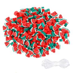 red and green watermelon shaped buttons with white string on the bottom, sitting in front of a white background