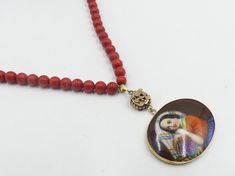 "Vintage gold filled clasp with dyed coral beads and gold filled antique hand pendant necklace, In good antique vintage condition. The pendant a bit little worn. Necklace 16\" ½ long. Pendant 2\" ½ long. Antique gold filled hand painted pendant 1\" 7/8 x 1\" 3/8. dyed coral beads 7 mm in diameter. It's no marker but has been tested gold filled. Weighs 46. 3 gram. Thanks." Vintage Single Strand Red Coral Beaded Necklaces, Vintage Single Strand Red Coral Beaded Necklace, Vintage Red Coral Single Strand Beaded Necklace, Antique Single Strand Beaded Necklace Gift, Vintage Red Coral Round Bead Necklaces, Antique Single Strand Beaded Necklace As Gift, Vintage Red Coral Necklace With Round Beads, Vintage Red Coral Round Bead Necklace, Antique Single Strand Necklace