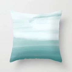 a blue and white pillow sitting on top of a wall