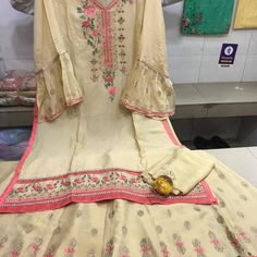 Tunic Top With Long Skirt With Thread Embroidery. This Is Semi Stitched So Can Be Stitched To Size. Fitted Beige Georgette Set, Off White Embroidered Georgette Dress, Off White Silk Sets With Floral Embroidery, Fitted Silk Sets In Off White, Fitted Off White Silk Set, Silk Fitted Sharara With Multicolor Embroidery, Fitted Silk Sharara With Multicolor Embroidery, Off White Embroidered Semi-stitched Dress, Summer Silk Sets In Cream Color