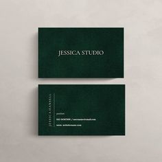 two green business cards with white lettering on them