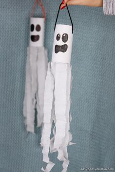 someone is holding up some toilet paper roll crafts with eyes and mustaches on them