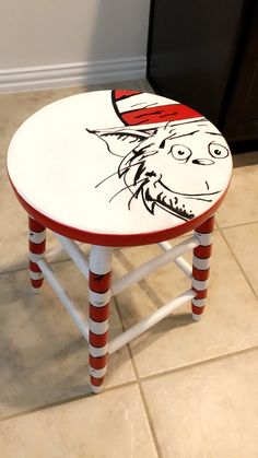 a cat in the hat stool painted with red and white stripes