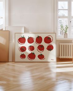 an art piece with tomatoes on it sitting in front of a radiator next to a window