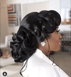 a woman with long black hair in a white dress and earrings on her head, looking off into the distance