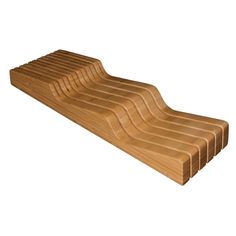 a wooden cutting board with wavy lines on the top and bottom, set against a white background