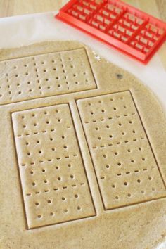 an uncooked pizza sitting on top of a table next to a red grater