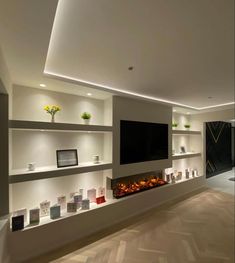 a living room filled with furniture and a flat screen tv mounted on a wall above a fire place