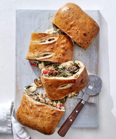 two sandwiches cut in half on a cutting board