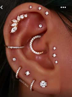 a woman's ear with three different piercings on it, including an ear cuff and