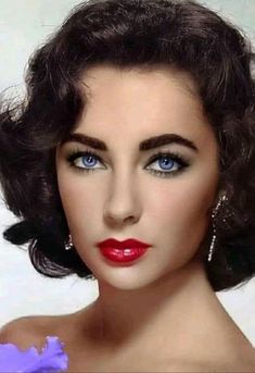 a woman with blue eyes and red lipstick