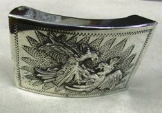 "Sterling silver belt buckle. 3 1/8\" wide x 2 1/16\" tall. The inside is stamped sterling Mexico DVll. Frank Tucker 1974 Ensenada is engraved on the inside. This will work with a 2\" or smaller belt. There are two birds who appear to be fighting as a design. There are some surface scratches from being worn. Still wearable. SBKL-1" Western Engraved Belt Buckles For Formal Wear, Antique Engraved Belt Buckles For Formal Wear, Classic Silver Belt Buckles With Polished Finish, Silver Engraved Rectangular Belt Buckles, Silver Rectangular Engraved Belt Buckles, Rectangular Engraved Silver Belt Buckles, Rectangular Silver Engraved Belt Buckles, Antique Engraved Belt Buckles For Gift, Antique Engraved Belt Buckle Gift