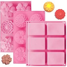 three different types of flower molds in pink trays and one with flowers on them