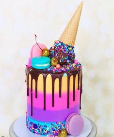 a colorful cake with ice cream, sprinkles and candy on the top